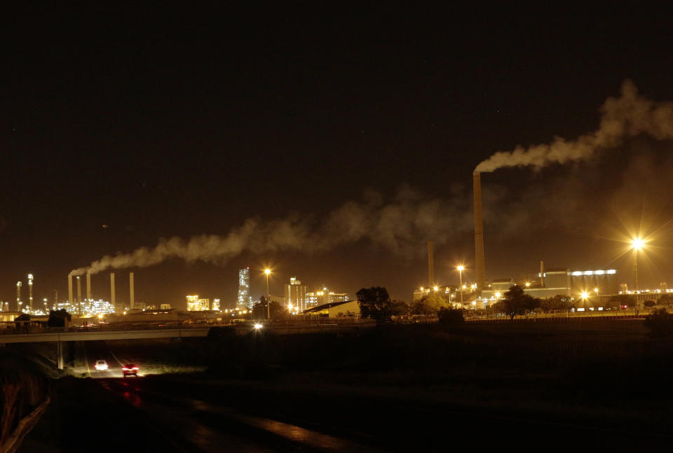 A night view of Sasol Plant, a plant that produces petrol and diesel from coal, in Sasolburg, South Africa, Tuesday, Dec. 4, 2018. The two-week U.N. climate meeting in Poland is intended to finalize details of the 2015 Paris accord on keeping average global temperature increases well below 2 degrees Celsius (3.6 Fahrenheit). (AP Photo/Themba Hadebe)