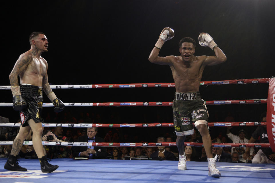 United States' Devin Haney, right, raises his hands after fighting George Kambosos Jr. of Australia as Haney defends his undisputed lightweight boxing title in Melbourne, Sunday, Oct. 16, 2022. (AP Photo/Hamish Blair)