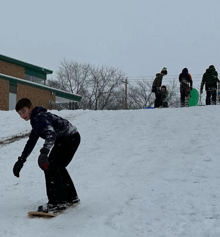 Kids sled and snowboard down the gently sloping hill at the Friends of New Troy Community Center in New Troy in southwest Michigan.