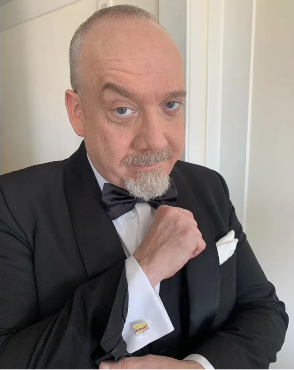 Paulin tuxedo with a bow tie, looking at the camera, wearing In-N-Out logo cufflinks