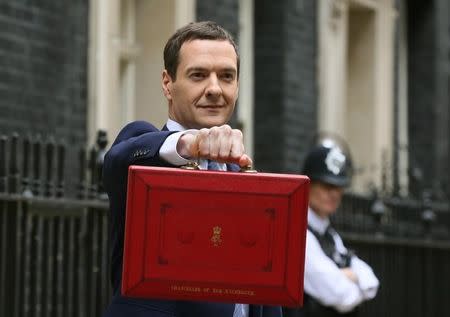 Britain's Chancellor of the Exchequer, George Osborne, holds up his budget case for the cameras as he stands outside number 11 Downing Street, before delivering his budget to the House of Commons, in London, Britain July 8, 2015. REUTERS/Paul Hackett