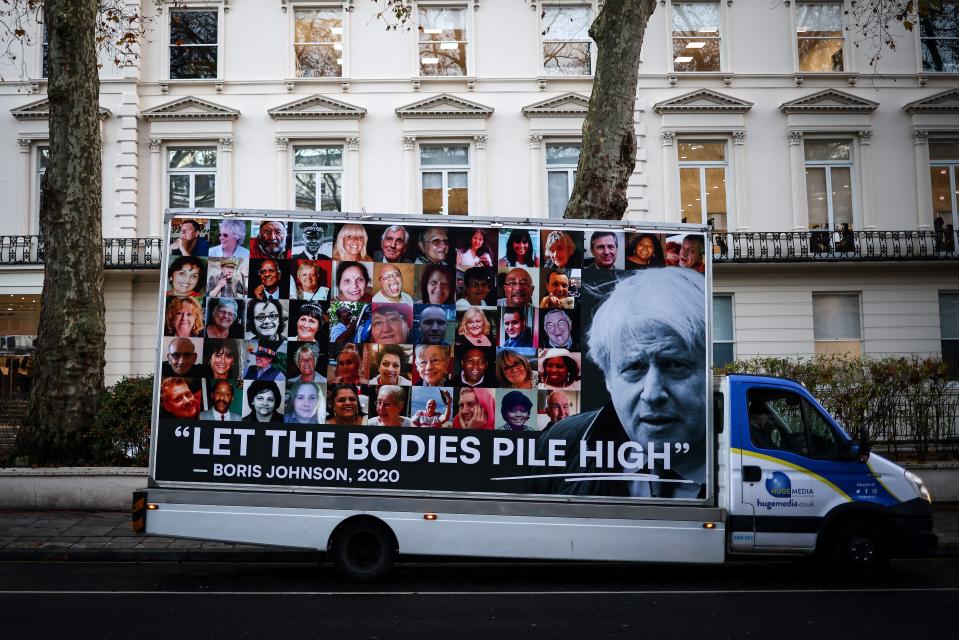 A vehicle transporting a placard is parked in front of the entrance of the UK Covid-19 Inquiry building, in west London, on Wednesday (AFP via Getty Images)