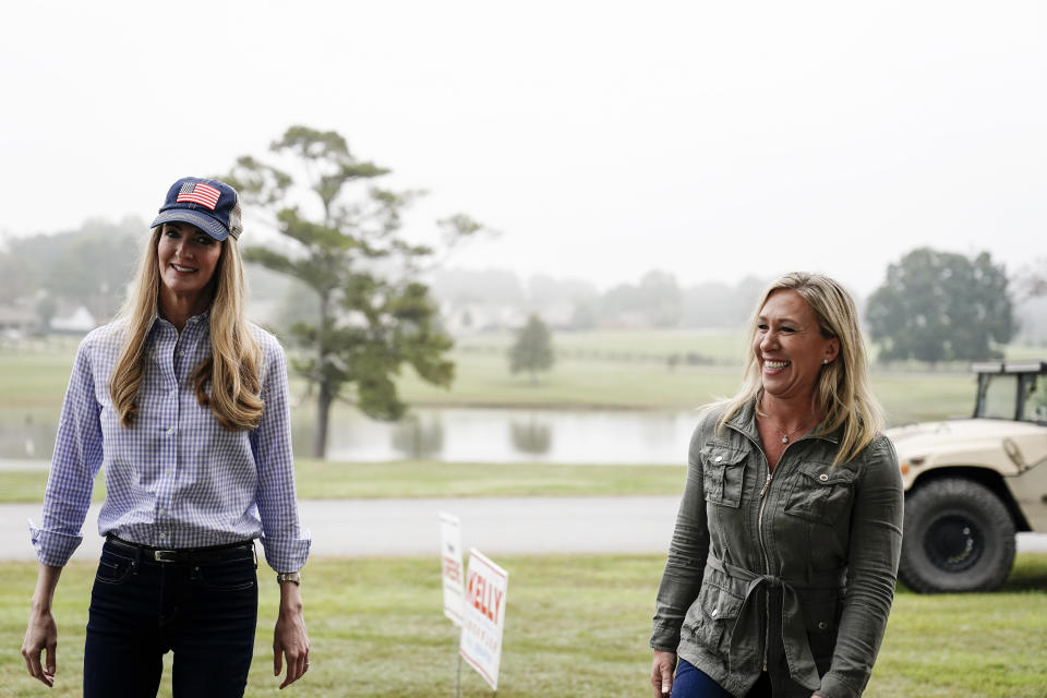 Sen. Kelly Loeffler, R-Ga., left, and Republican congressional candidate Marjorie Taylor Greene, right, arrive a news conference on Thursday, Oct. 15, 2020, in Dallas, Ga. (AP Photo/Brynn Anderson)