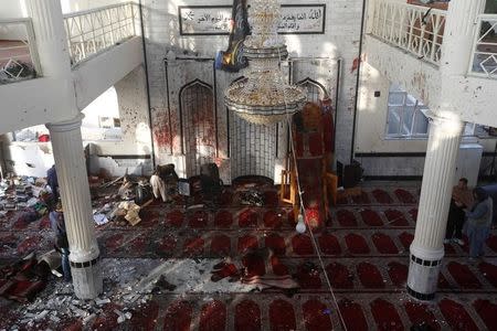 ATTENTION EDITORS - VISUAL COVERAGE OF SCENES OF INJURY OR DEATH Afghan men inspect inside a Shi'ite Muslim mosque after last night attack in Kabul, Afghanistan October 21, 2017. REUTERS/Omar Sobhani