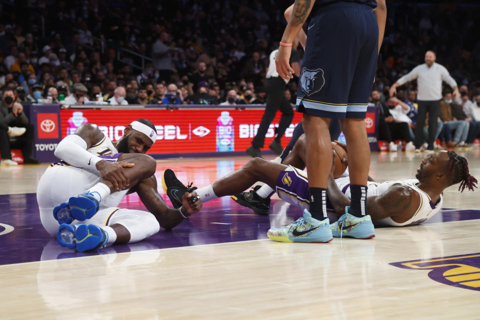 Los Angeles Lakers forward LeBron James (6) reacts after colliding with Los Angeles Lakers center Dwight Howard (39) during the first half of an NBA basketball game against the Memphis Grizzlies in Los Angeles, Sunday, Oct. 24, 2021. (AP Photo/Ringo H.W. Chiu)