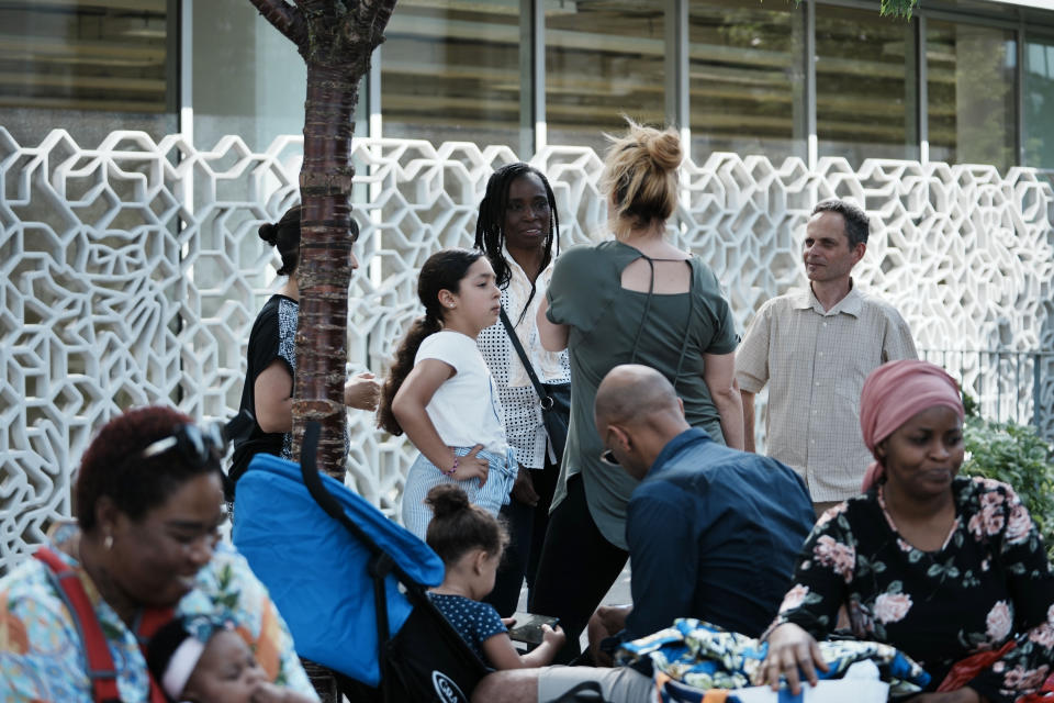 Hard-left candidate for the legislative election, Rachel Keke, center background, speak with residents of Fresnes, south of Paris, ahead of the second round of the legislative elections, Thursday, June 16, 2022. The former chambermaid, Rachel Keke, took the stand during political rallies across France, to speak about her grueling but successful battle against French hotel giant Accor to obtain better work pay and conditions. (AP Photo/Thibault Camus)