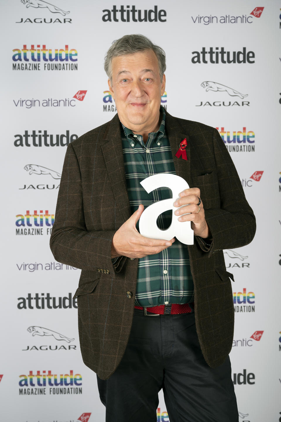 Actor Stephen Fry poses with The Icon Award during the Virgin Atlantic Attitude Awards Powered By Jaguar broadcast on  December 01, 2020 in London, England. (Photo by Attitude Magazine/Attitude Magazine via Getty Images)