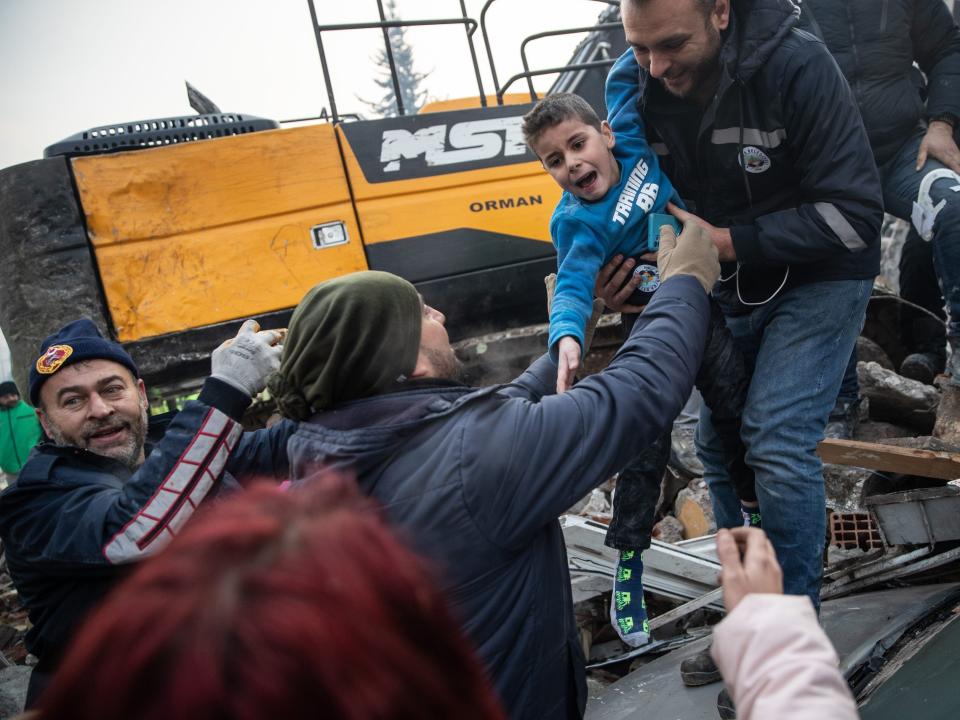 Rescue workers carry Yigit Cakmak, 8-years-old survivor at the site of a collapsed building 52 hours after the earthquake struck, on February 08, 2023 in Hatay, Turkey. A 7.8-magnitude earthquake hit near Gaziantep, Turkey, in the early hours of Monday, followed by another 7.5-magnitude tremor just after midday.