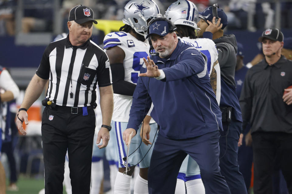 Dallas Cowboys head coach Mike McCarthy, right, gestures while talking to an official during the first half of his team's NFL wild-card playoff football game against the San Francisco 49ers in Arlington, Texas, Sunday, Jan. 16, 2022. (AP Photo/Ron Jenkins)