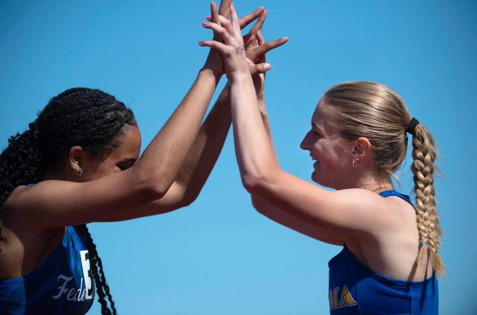 Federal Way’s Cassandra Atkins (left) congratulates Tahoma’s Brooke Lynn following her state title in the 4A girls 200 meters during the final day of the WIAA state track and field championships at Mount Tahoma High School in Tacoma, Washington, on Friday, May 26, 2023.
