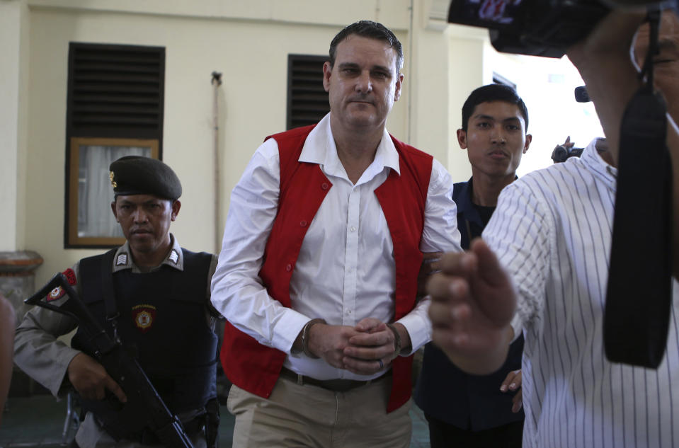 Australian Troy Smith, center, is escorted by police to a courtroom for his first hearing trial at Denpasar district court Bali, Indonesia on Thursday, June 13, 2024. Indonesian police arrested Smith on April 30, allegedly being caught with methamphetamine in his hotel.(AP Photo/Firdia Lisnawati)