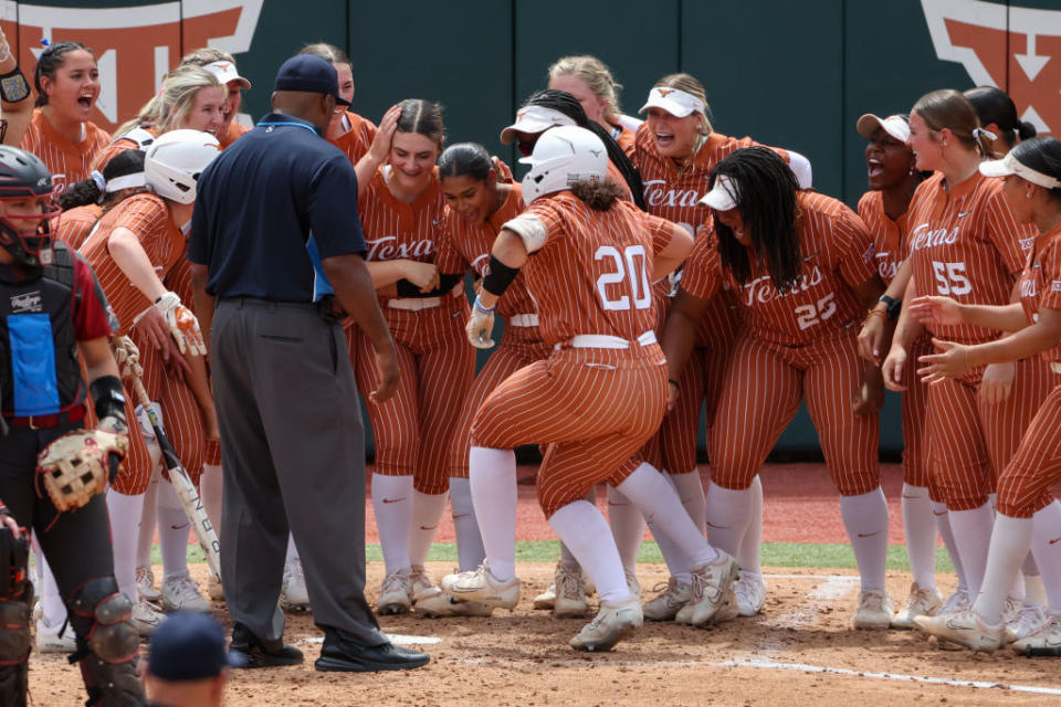 AUSTIN, TX – APRIL 07: Texas catcher Katie Stewart (20) is met at home plate by her teammates after hitting a two run home run during the Big 12 college softball game between Texas Longhorns and Oklahoma Sooners on April 7, 2024, at Red & Charline McCombs Field in Austin, TX. (Photo by David Buono/Icon Sportswire via Getty Images)