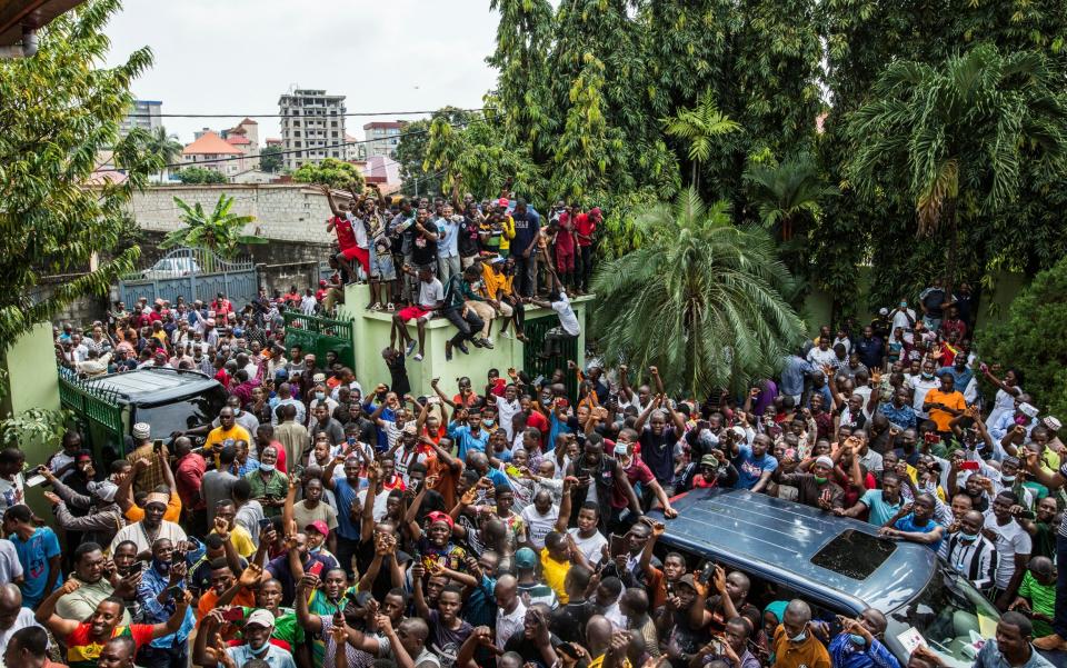 Supporters of Guinean opposition leader Cellou Dalein Diallo cheer - AP