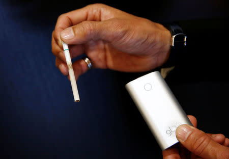 A staff of British American Tobacco Japan shows displays a tobacco after smoking using its new tobacco heating system device 'glo', following a news conference in Tokyo, Japan, November 8, 2016. REUTERS/Kim Kyung-Hoon