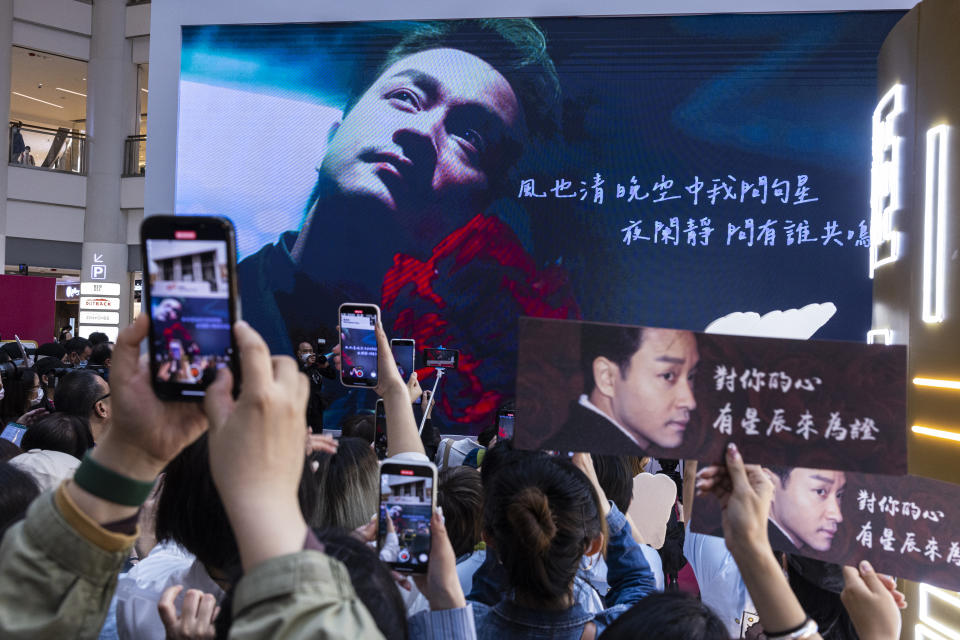 Fans gather during an event commemorating the 20th anniversary of the death of Canto-pop singer Leslie Cheung at a shopping mall in Hong Kong, Friday, March 31, 2023. Fans of Cheung, one of the first singers to come out as gay in Hong Kong, flocked to the city this week to commemorate their idol’s death 20 years ago, revisiting his legacy of pioneering work made during a socially conservative time. (AP Photo/Louise Delmotte)