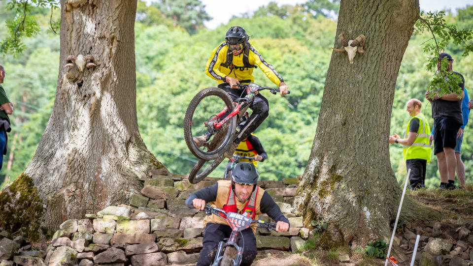 Riders jumping a rock feature