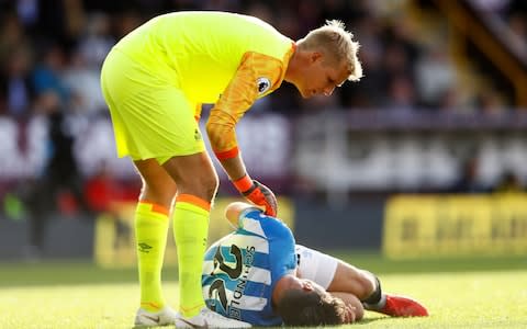 Huddersfield Town's Christopher Schindler down injured with Jonas Lossl  - Credit: Jason Cairnduff/Reuters