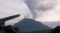 Indonesia's mount Sinabung erupts, ejecting volcanic ashes from its crater and forcing villagers to evacuate their houses. Rough Cut (no reporter narration).