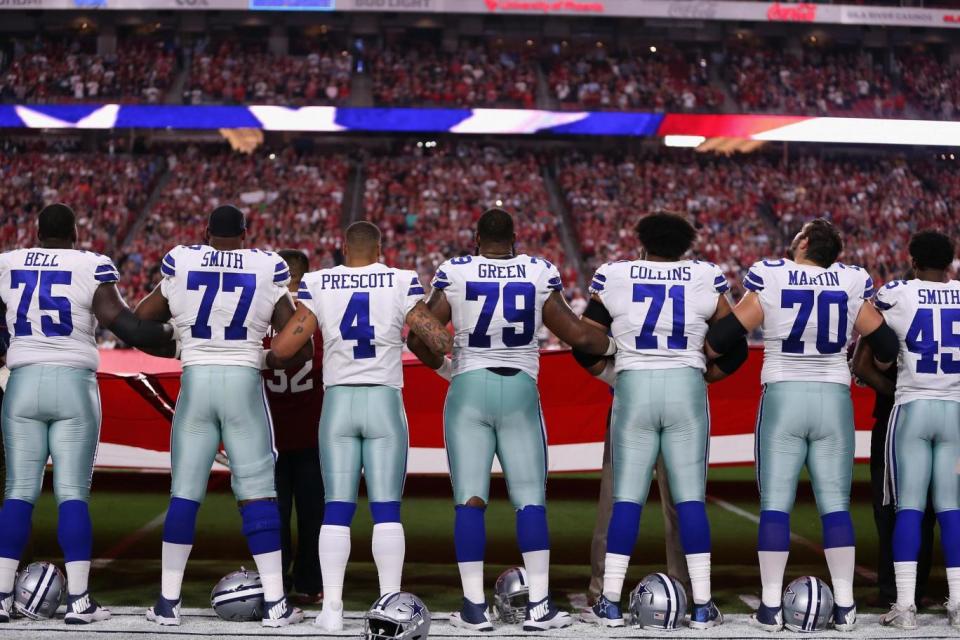 Respect: The players stood arm-in-arm as the anthem was sung (Getty Images North America)