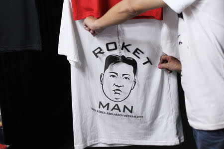 A man selling t-shirts with the image of North Korean leader Kim Jong Un displays a design ahead of the North Korea–United States Hanoi Summit in Hanoi, Vietnam February 21, 2019. REUTERS/Jorge Silva