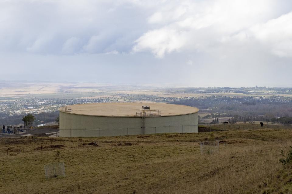 A water tank on Wednesday, Sept. 27, 2023, in Kula, Hawaii, that was part of a system that lost pressure during wildfires. A lack of backup power for critical pumps seriously hindered firefighting in Kula, county water director John Stufflebean told The Associated Press. Once the winds knocked out electricity, pumps were unable to push water up into tanks and reservoirs that were key to maintaining pressure. (AP Photo/Mengshin Lin)