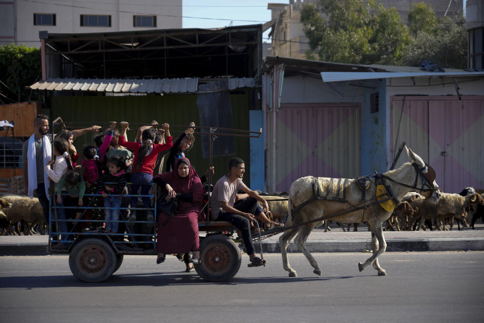 Palestinians flee to the southern Gaza Strip on Salah al-Din Street in Bureij, Gaza Strip, Tuesday, Nov. 7, 2023. (AP Photo/Hatem Moussa)