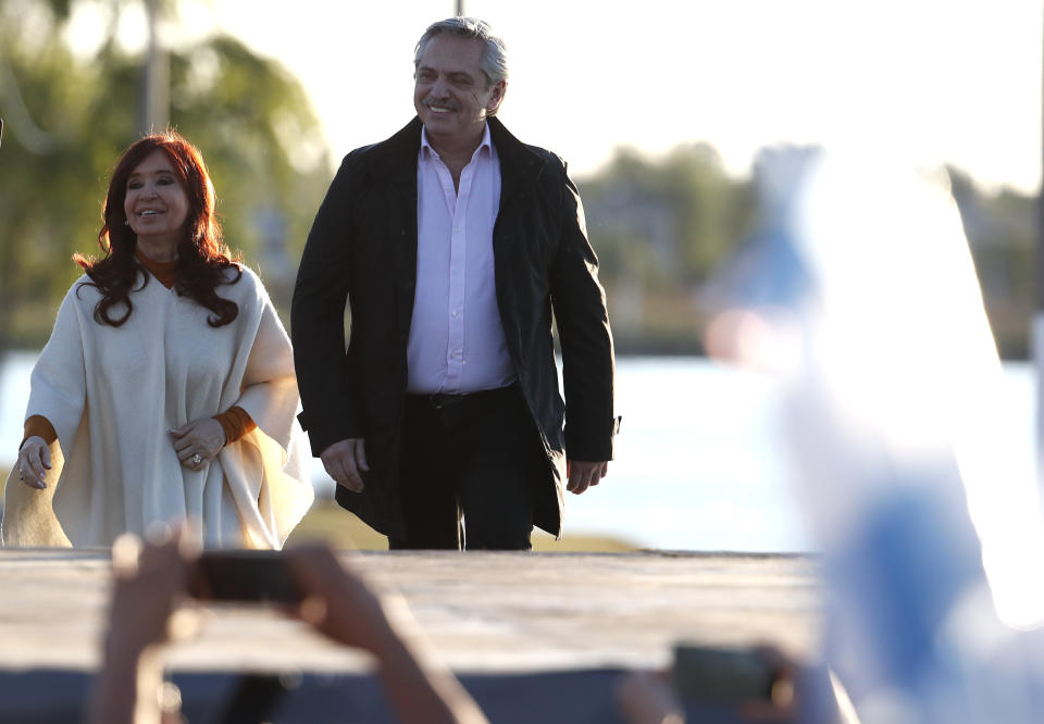 In this Oct. 17, 2019 photo, presidential frontrunner Alberto Fernandez, right, and running-mate Cristina Fernandez de Kirchner, arrive for a campaign rally in Santa Rosa, Argentina. Fernandez de Kirchner, Argentina’s former president, is close to a return to power - this time as a vice presidential candidate - ahead of Oct. 27 elections. (AP Photo/Natacha Pisarenko)