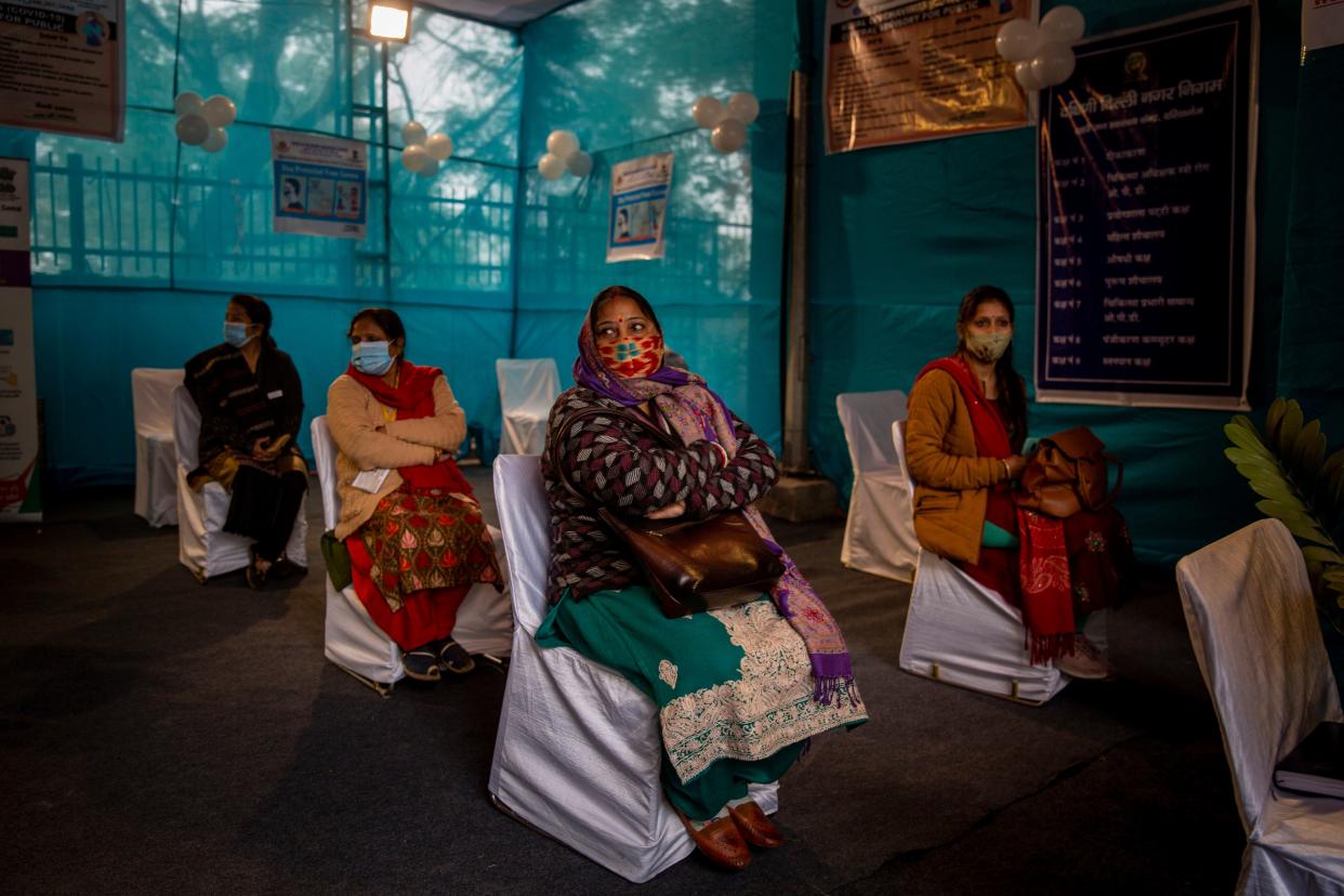 People participating in a COVID-19 vaccine delivery system trial wait for their turn at a COVID-19 vaccination center in New Delhi, India on Saturday, Jan. 2, 2021. India tested its COVID-19 vaccine delivery system with a nationwide trial on Saturday as it prepares to roll-out an inoculation program to stem the coronavirus pandemic. Saturday's exercise included necessary data entry into an online platform for monitoring vaccine delivery, along with testing of cold storage and transportation arrangements for the vaccine, the health ministry had said.