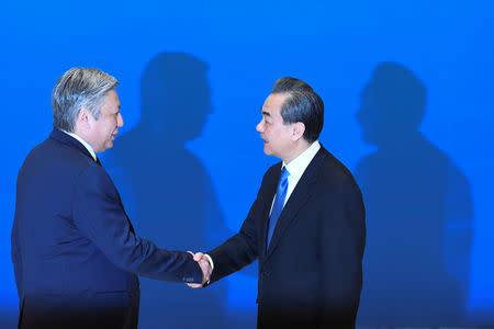 Kyrgyz Foreign Minister Erlan Abdyldaev (left) shakes hands with Chinese State Councilor and Foreign Minister Wang Yi before a meeting of foreign ministers and officials of the Shanghai Cooperation Organisation (SCO) at the Diaoyutai State Guest House in Beijing, China, April 24, 2018. MADOKA IKEGAMI/Pool via REUTERS