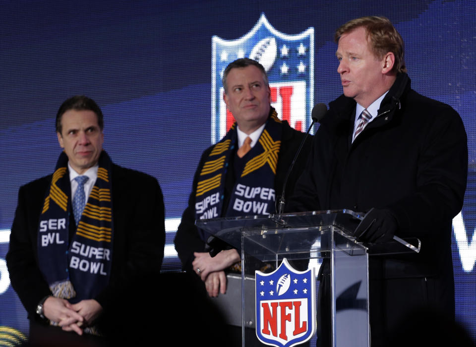 NFL comissioner Roger Goodell, right, speaks while New York City Mayor Bill de Blasio, center, and New York Gov. Andrew Cuomo, left, look on during a ceremony unveiling the Roman numerals for Super Bowl XLVIII on Super Bowl Boulevard Wednesday, Jan. 29, 2014, in New York. The Seattle Seahawks are scheduled to play the Denver Broncos in the NFL Super Bowl XLVIII football game on Sunday, Feb. 2, in East Rutherford, N.J. (AP Photo/Charlie Riedel)