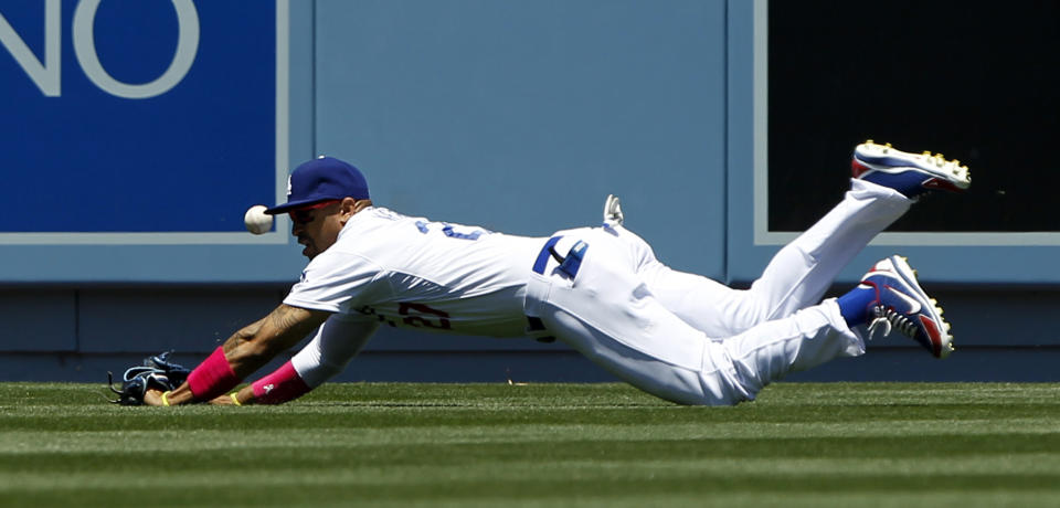 Los Angeles Dodgers center fielder Matt Kemp dives, but misses the ball on an RBI double by San Francisco Giants' Pablo Sandoval in the first inning of a baseball game on Sunday, May 11, 2014, in Los Angeles. (AP Photo/Alex Gallardo)