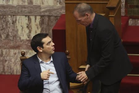 Greece's new leftist finance minister Yanis Varoufakis (R) talks with Greek Prime Minister Alexis Tsipras in the parliament in Athens, February 6, 2015. REUTERS/Panayiotis Tzamaros/FOSPHOTOS