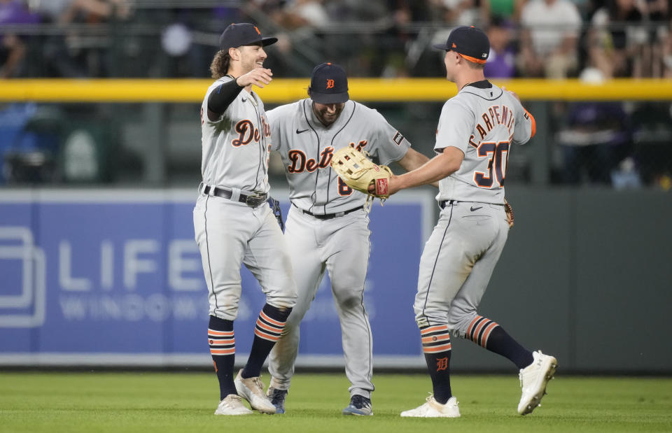 From left to right, Detroit Tigers left fielder Zach McKinstry, center fielder Matt Vierling and right fielder Kerry Carpenter celebrate after the 10th inning of a baseball game against the Colorado Rockies, Saturday, July 1, 2023, in Denver. (AP Photo/David Zalubowski)