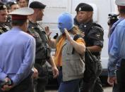 Police detain a supporter (C) of the female punk band "Pussy Riot" members for taking part in an unsanctioned rally outside a court building in Moscow, August 17, 2012.