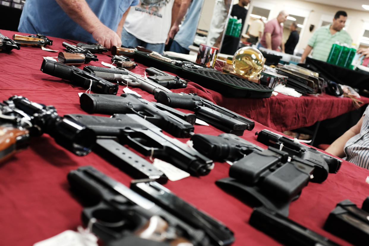 Various guns displayed on a table.