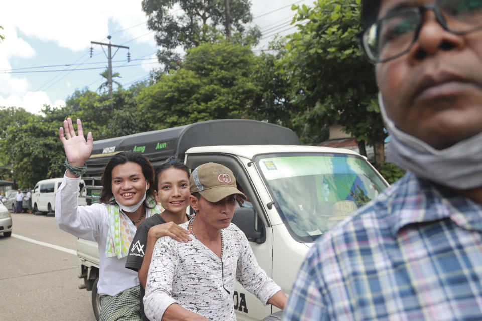 A detainee waves from a motorbike after being released from the Insein Prison, Tuesday, Oct. 19, 2021, in Yangon, Myanmar. Myanmar's government on Monday announced an amnesty for thousands of prisoners arrested for taking part in anti-government activities following February's seizure of power by the military. (AP Photo)