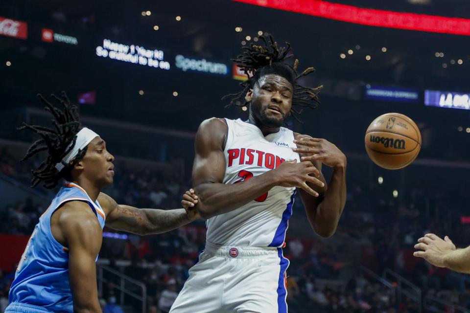 Detroit Pistons forward Isaiah Stewart, right, struggles with a rebound next to Los Angeles Clippers guard Terance Mann during the first half of an NBA basketball game, Friday, Nov. 26, 2021, in Los Angeles. (AP Photo/Ringo H.W. Chiu)