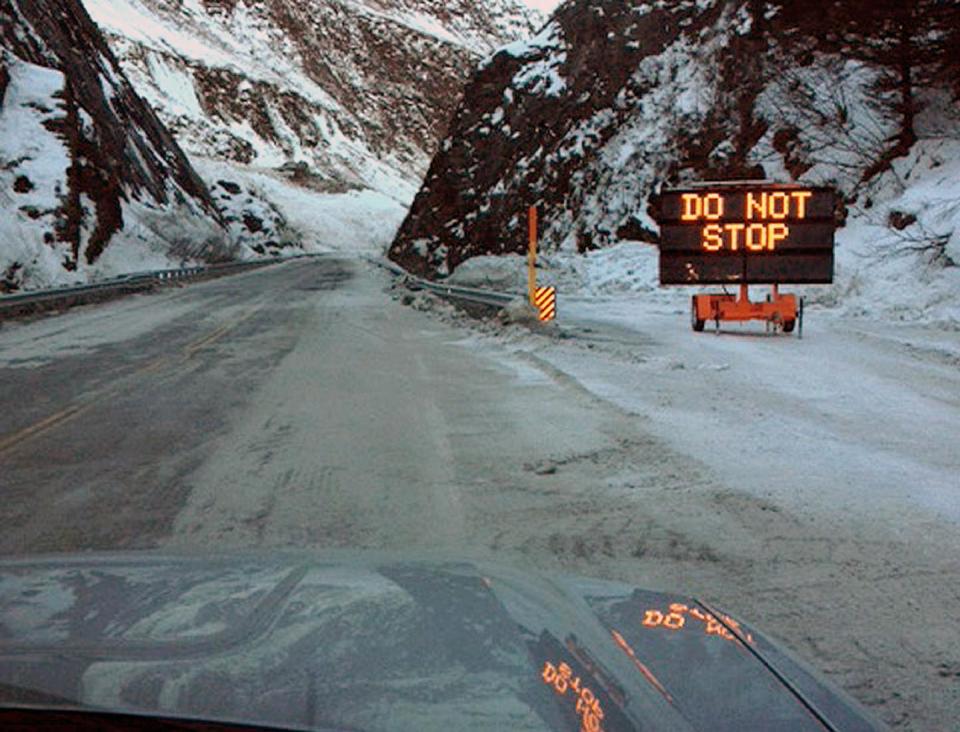 This Feb. 5, 2014 photo released by the Alaska Department of Transportation & Public Facilities shows Richardson Highway at Keystone Canyon, Valdez, Alaska. On Wednesday Feb. 5, 2014 two weeks after cascades of snow prevented vehicles from getting into the only road to Valdez has reopened. Crews finished clearing away the remaining avalanche debris, and there was no damage to Richardson Highway. (AP Photo/Alaska Department of Transportation & Public Facilities)