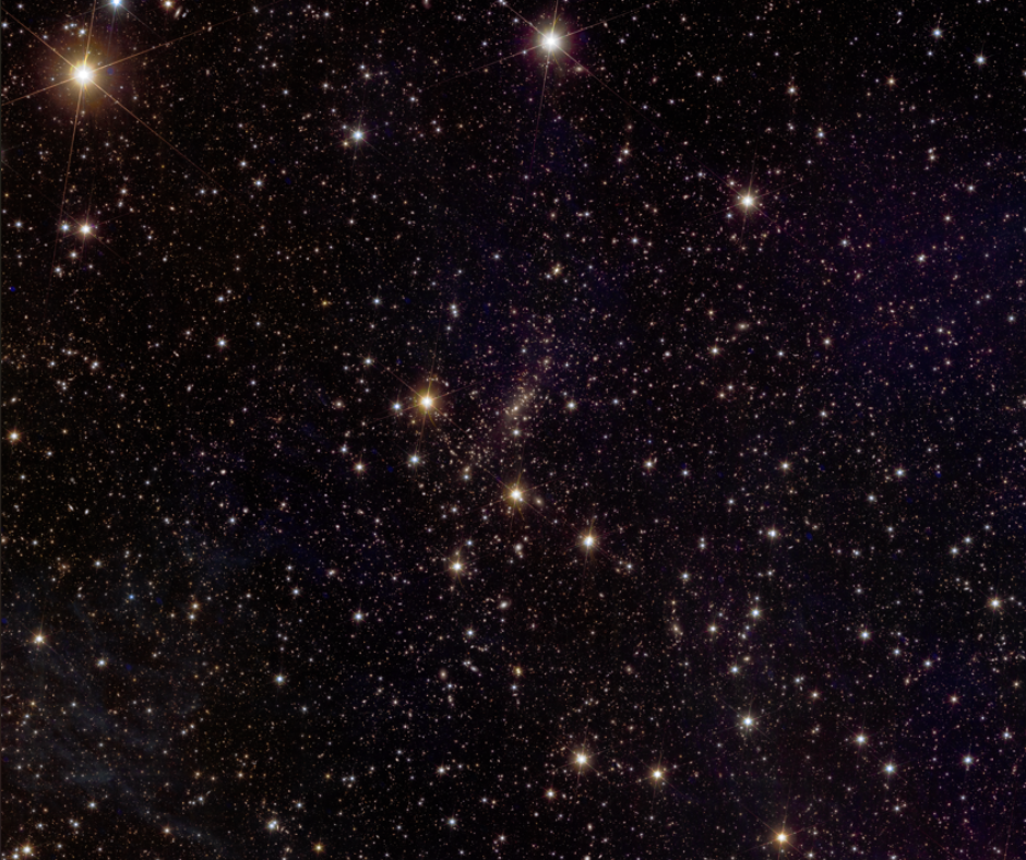 A dark section of space with tons of speckles of light. Some of those speckles are slightly concentrated in the center, but it's still very sparse.