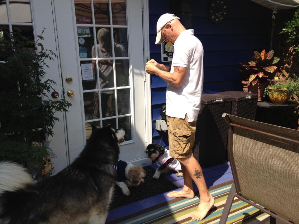 This July 2013 photo shows chef Patrick Richardson with the resident dogs of the Bewitched & BEDazzled B&B in Rehoboth Beach, Del. The inn is one of a number of dog-friendly establishments in the Rehoboth Beach. (AP Photo/Inez Conover)