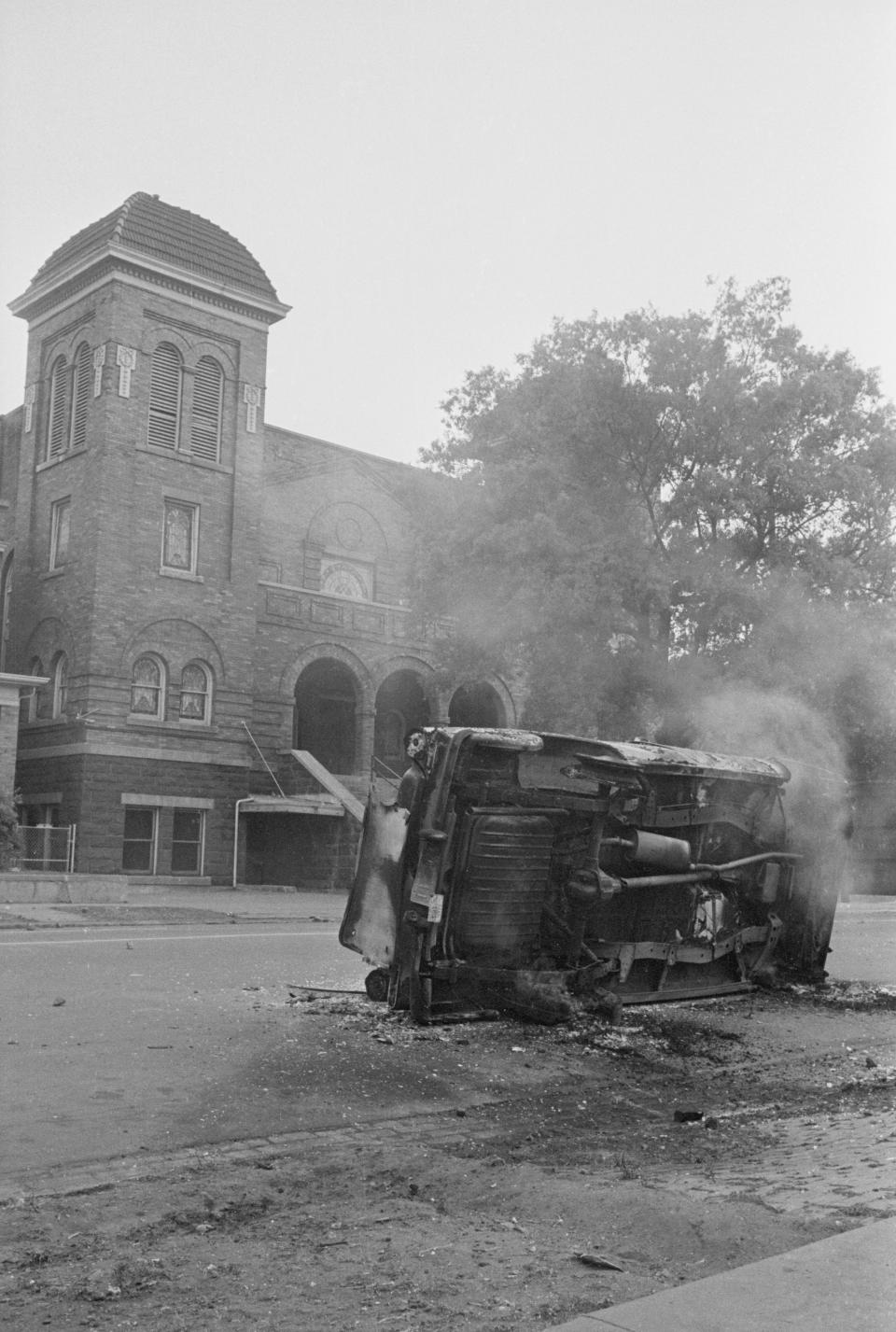 A charred automobile sits outside the 16th Street Baptist Church 