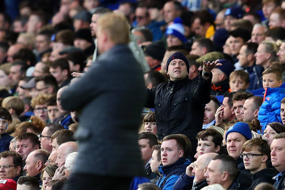 Ronald Koeman gets some abuse from a hat wearing Everton devotee.