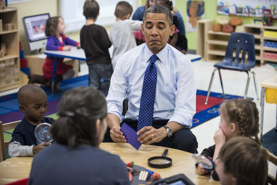 Obama plays a learning game while visiting children at College Heights Early Childhood Learning Center in Decatur, Georgia, in February 2012. (Photo: BRENDAN SMIALOWSKI via Getty Images)