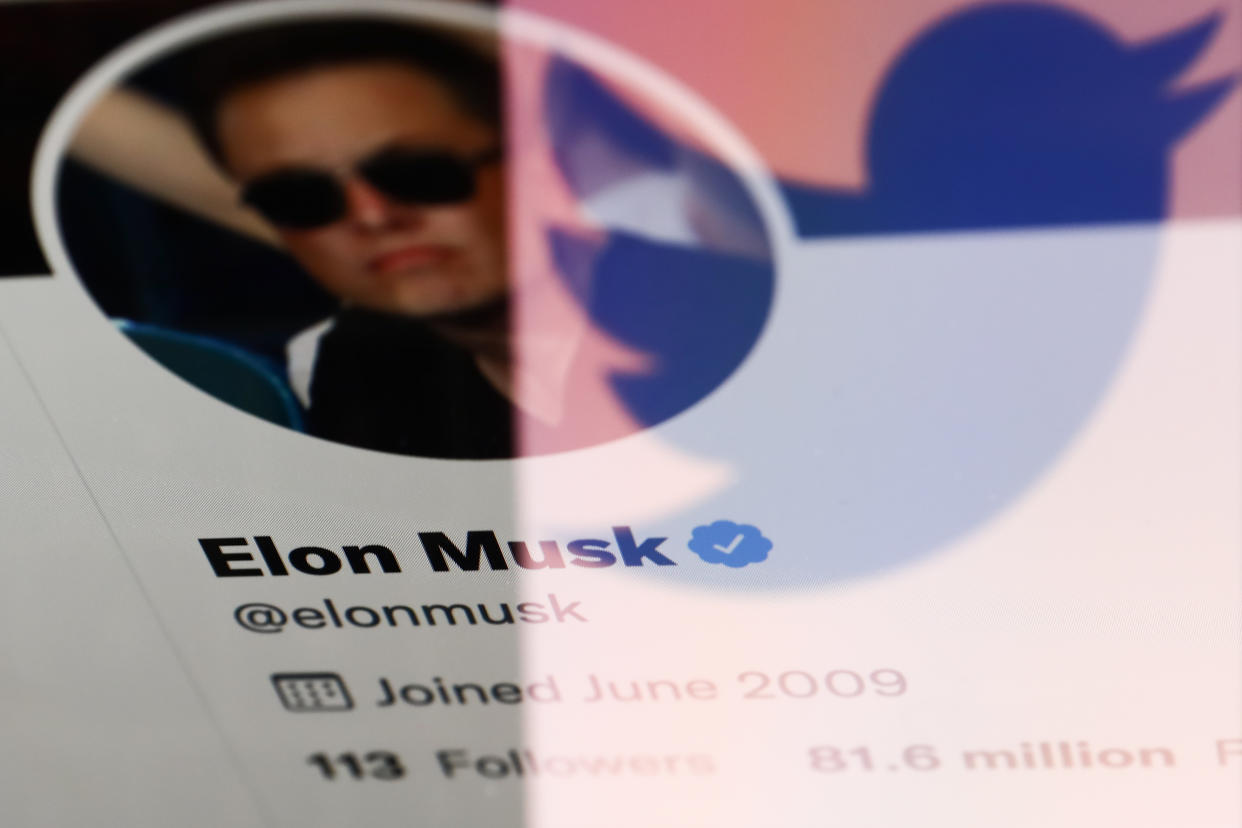 Elon Musk's Twitter profile displayed on a screen and reflceted Twitter logo displayed on a phone screen are seen in this illustration photo taken in Krakow, Poland on April 14, 2022. (Photo illustration by Jakub Porzycki/NurPhoto via Getty Images)