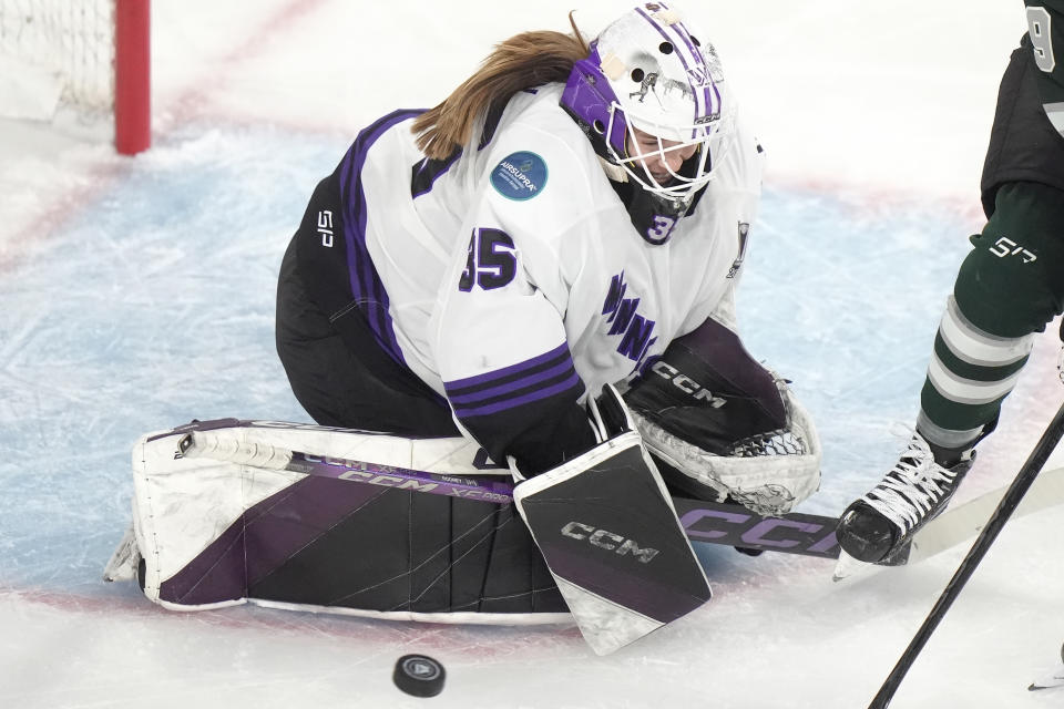 Minnesota goalie Maddie Rooney deflects the puck during the first period of Game 1 of a PWHL hockey championship series against Boston, Sunday, May 19, 2024, in Lowell, Mass. (AP Photo/Steven Senne)