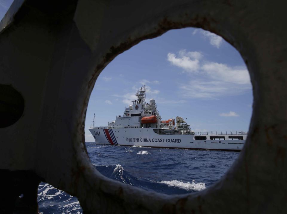 A China Coast Guard vessel attempts to block a Philippine government vessel as the latter tries to enter the China Second Thomas Disputed Shoals (local name Ayungin Shoal) to replace Philippine troops and resupply provisions Saturday, March 29, 2014 off the South China Sea. Chinese coast guard ships set up a blockade but a lone Philippine boat maneuvered past them in the high seas Saturday to deliver a fresh batch of Filipino troops and food supplies to a disputed shoal in a tense, cat-and-mouse-like confrontation witnessed for the first time by journalists in the South China Sea. (AP Photo/Bullit Marquez)