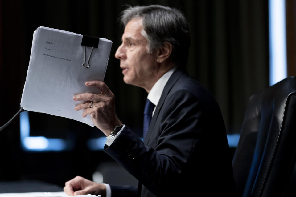 FILE - Secretary of State Antony Blinken holds up documents while speaking at a Senate Committee on Foreign Relations hearing on the U.S. withdrawal from Afghanistan, on Capitol Hill in Washington, Sept. 14, 2021. A year after America's tumultuous and deadly withdrawal from Afghanistan, assessments of its impact are divided — and largely along partisan lines. (AP Photo/Andrew Harnik, File)