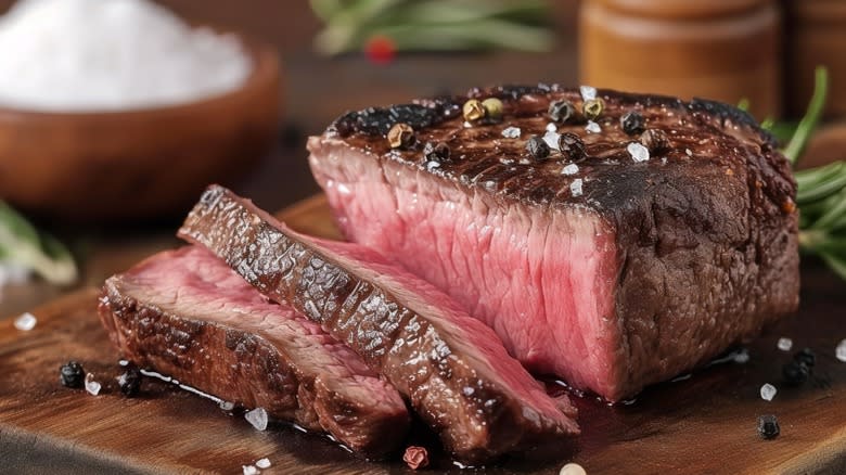Sliced steak with salt and rosemary