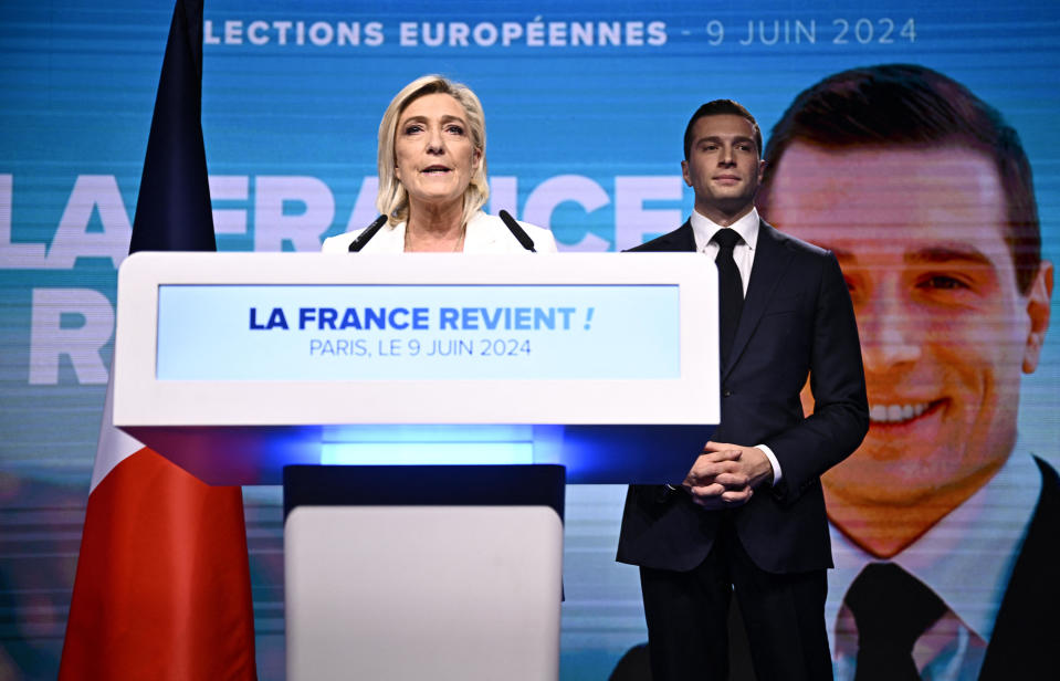 French far-right Rassemblement National (RN) party leader Marine Le Pen addresses supporters as party president Jordan Bardella listens during a gathering on the final day of the European Parliament election, in Paris, June 9, 2024. / Credit: JULIEN DE ROSA/AFP/Getty