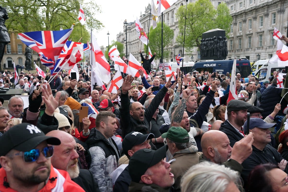 People wave flags during a St George's Day rally at Whitehall (Jordan Pettitt/PA Wire)